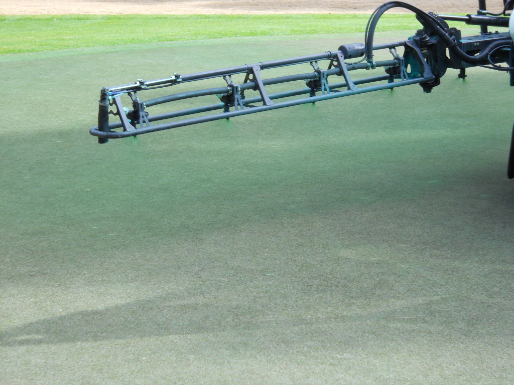 Closeup of applying the Endurant turf colorant using St. James Plantation's existing spraying equipment.